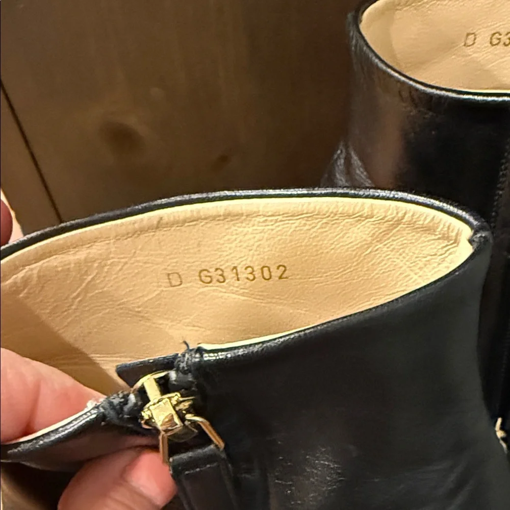 CHANEL Black Leather Wedge Boots with Gold Accent